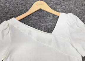 FallStil® - Solid white puffed short sleeve asymmetric top